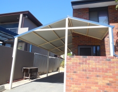 Steel carport and front door cover is practical and just what this Como family needed